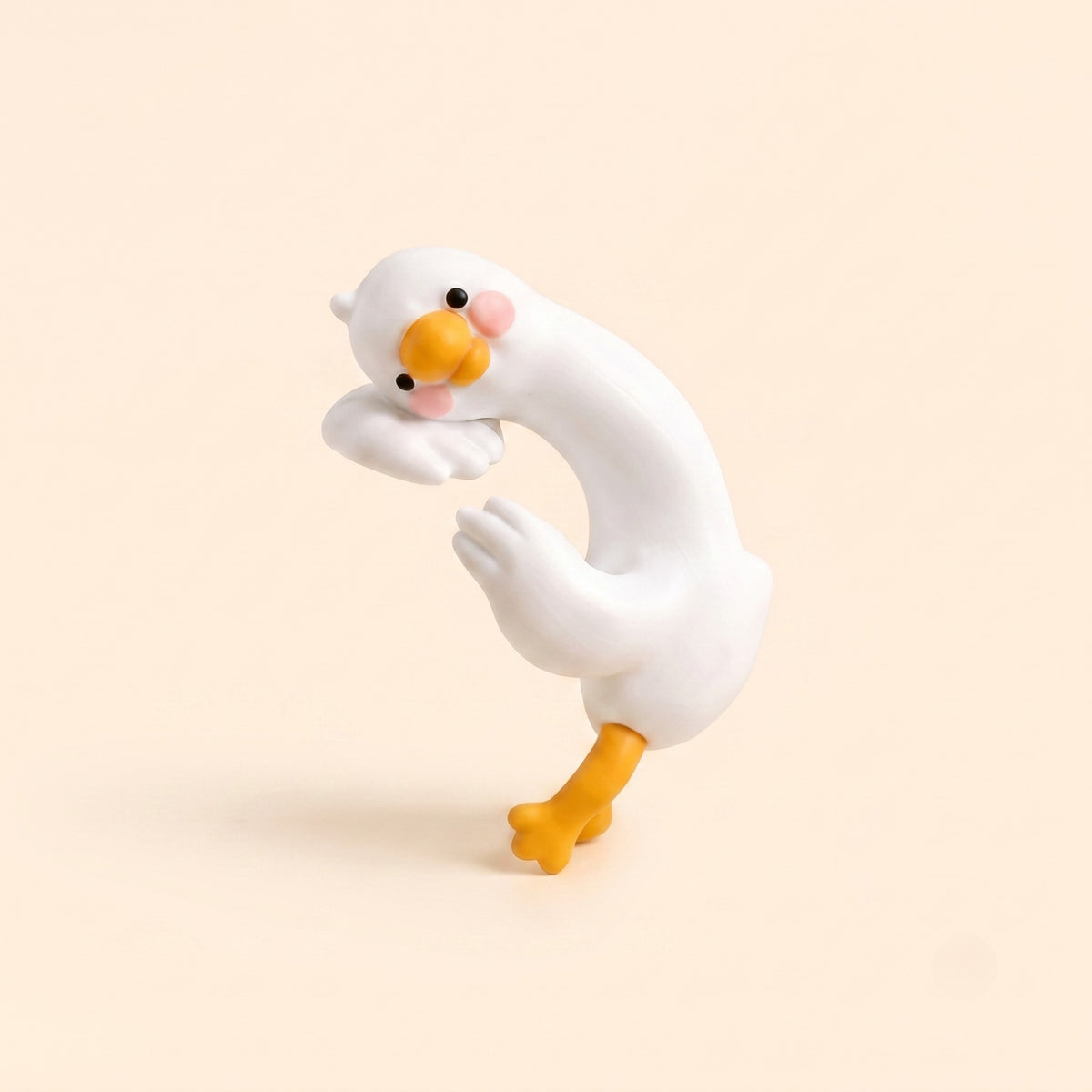 A minimalist studio shot of the By1994 mini duck figurine in the Climbing pose, showcasing a curved white resin duck designed to hug monitor or shelf edges