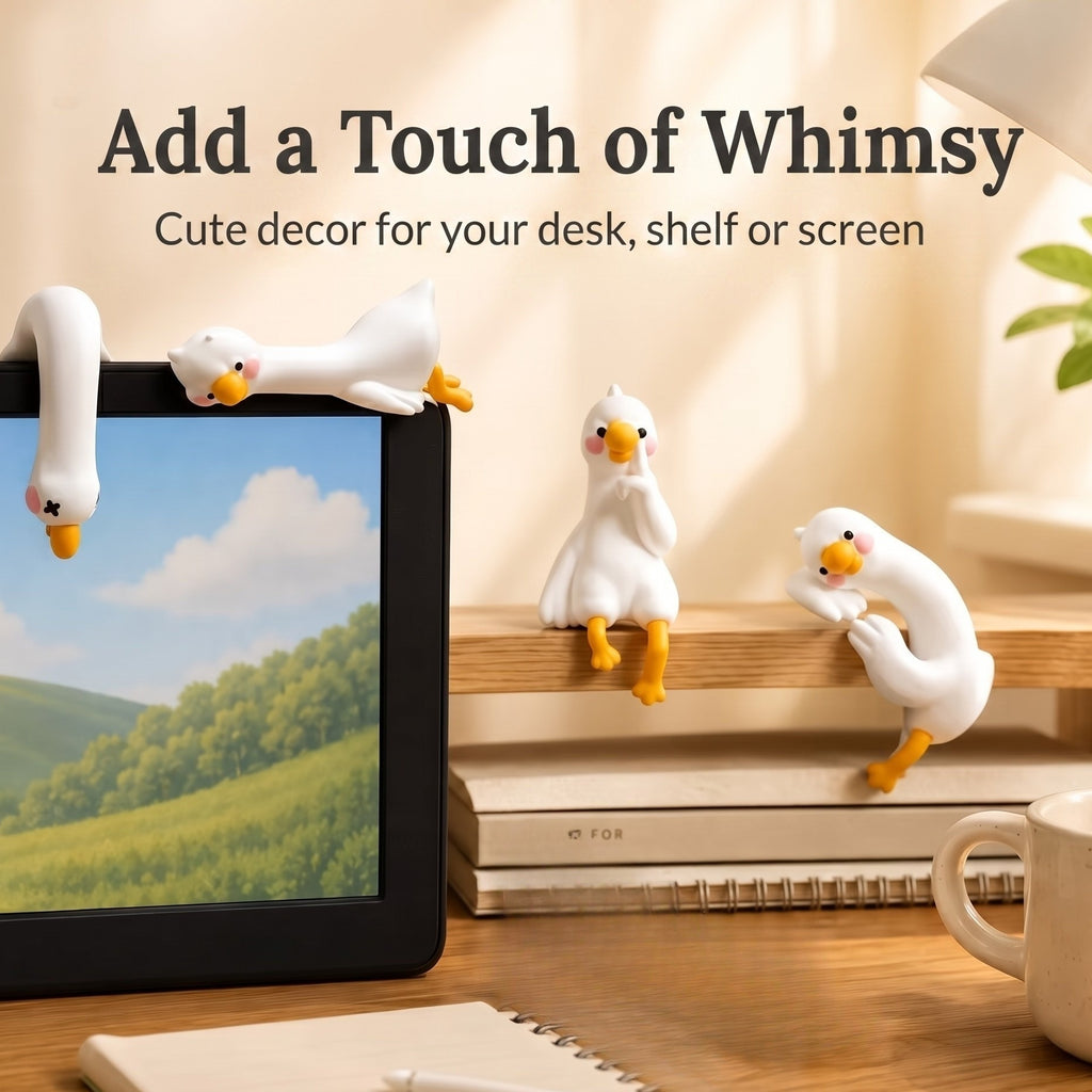 A cozy warm-toned lifestyle image featuring 4 mini duck figurines perched atop a computer screen, a wooden shelf, and a desk setup, with text overlay reading Add a Touch of Whimsy. Cute decor for your desk, shelf or screen.