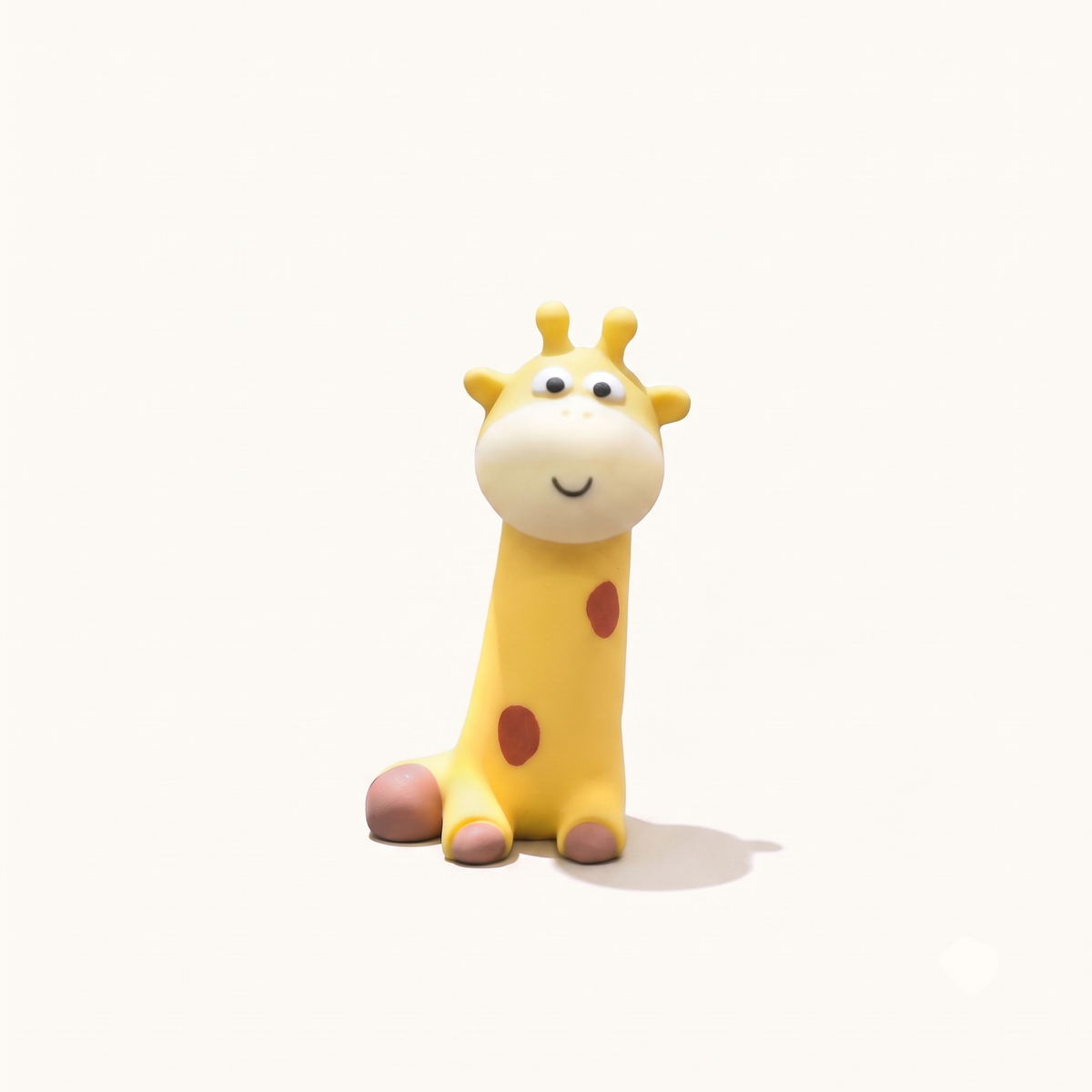 A clean studio product shot of the By1994 mini giraffe figure in a sitting upright posture with a smiling face, featuring hand-painted resin details on an off-white background.