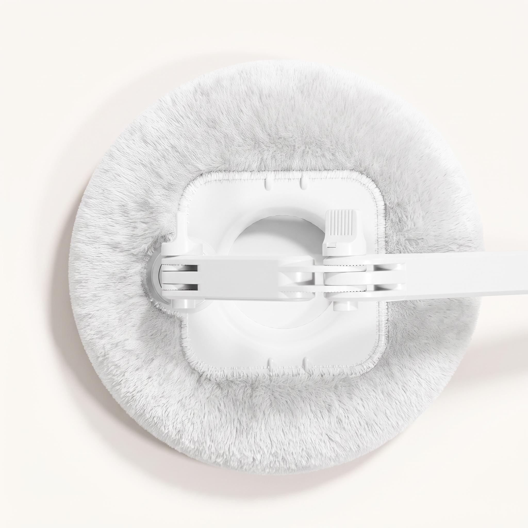 A direct top-down bird's-eye view looking into the center of the Ivory White plush pillow base, showcasing the integrated hollow square storage tray built directly beneath the mechanical arm base for holding snacks or small items.