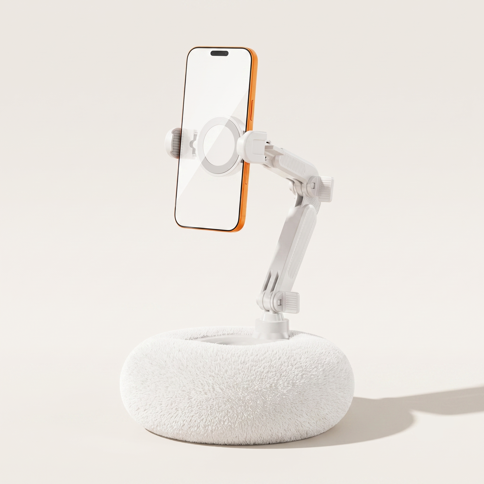 A crisp studio hero shot of the By1994 plush pillow phone holder in Ivory White, featuring a clean white mechanical arm holding a smartphone vertically on a light beige background.