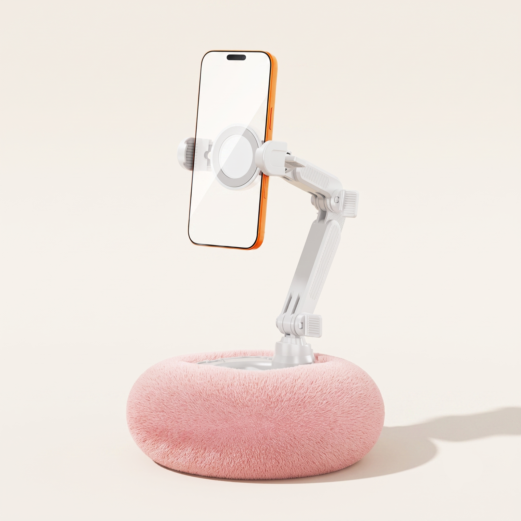 A clean studio view of the By1994 standard plush pillow phone holder in Soft Pink, holding a smartphone securely in a vertical position against a minimalist background.