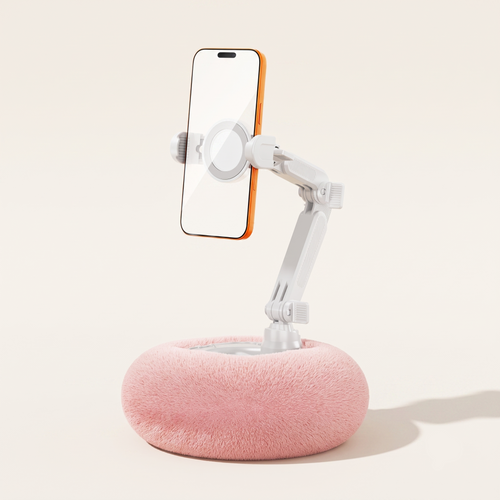 A clean studio view of the By1994 standard plush pillow phone holder in Soft Pink, holding a smartphone securely in a vertical position against a minimalist background.