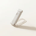 A crisp lifestyle hero image showcasing a white portable LED book light arranged beautifully on a clean canvas cream background.